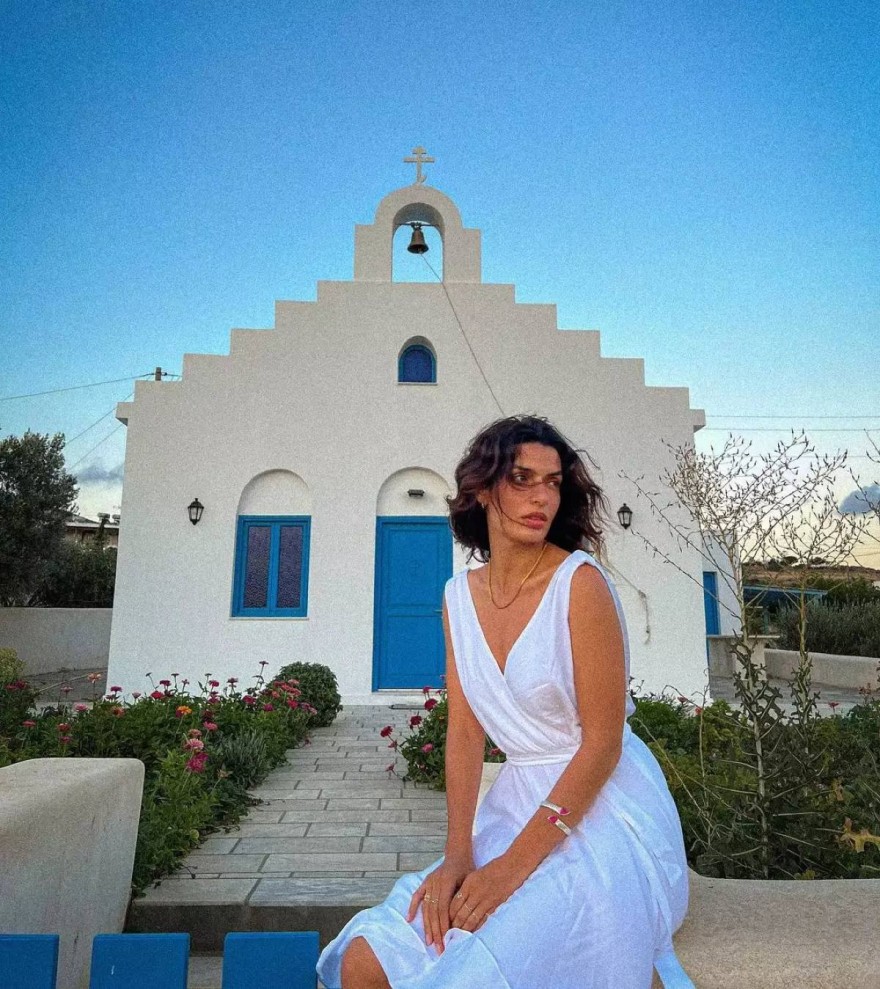 ΗΤόνια Σωτηροπούλου μπροστά από μια κυκλαδίτικη εκκλησία