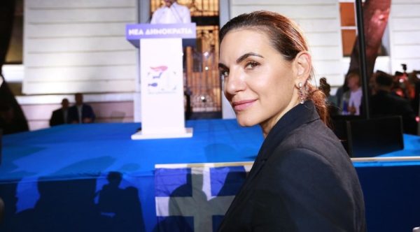 Η Όλγα Κεφαλογιάννη με μπλε σακάκι σε ομιλία