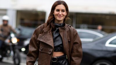 Κοπέλα με καφέ δερμάτινο μπουφάν στον δρόμο