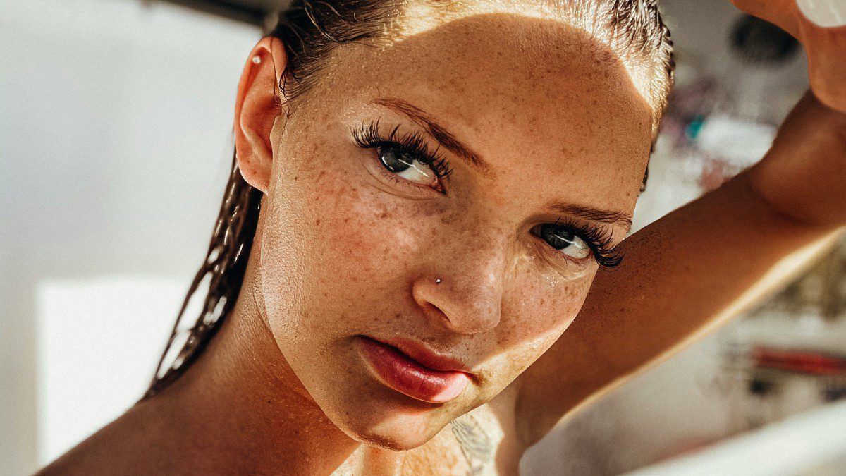 Μια κοπέλα με φακίδες ποζάρει στον ήλιο